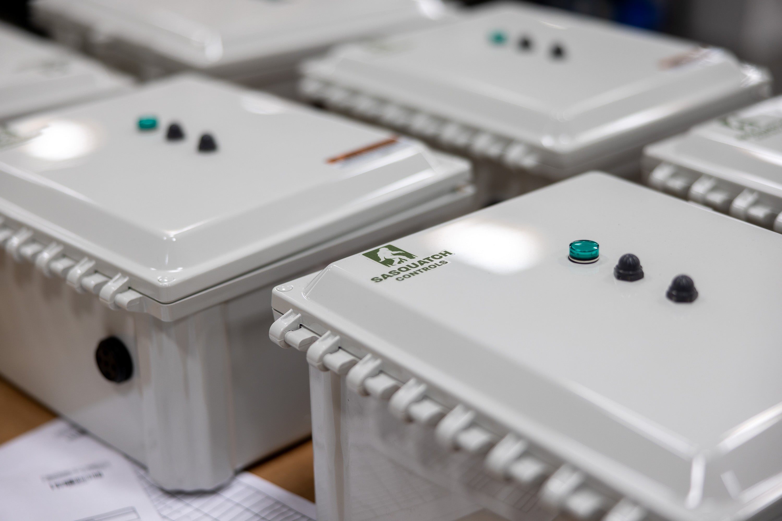 Multiple Sasquatch Controls control panels laying flat on work bench.
