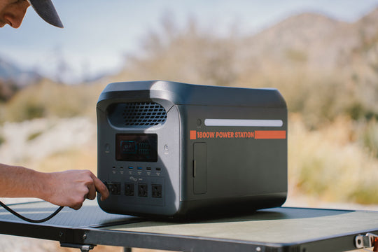 Man Plugging into Sasquatch 1800W Portable Power Station while Outside