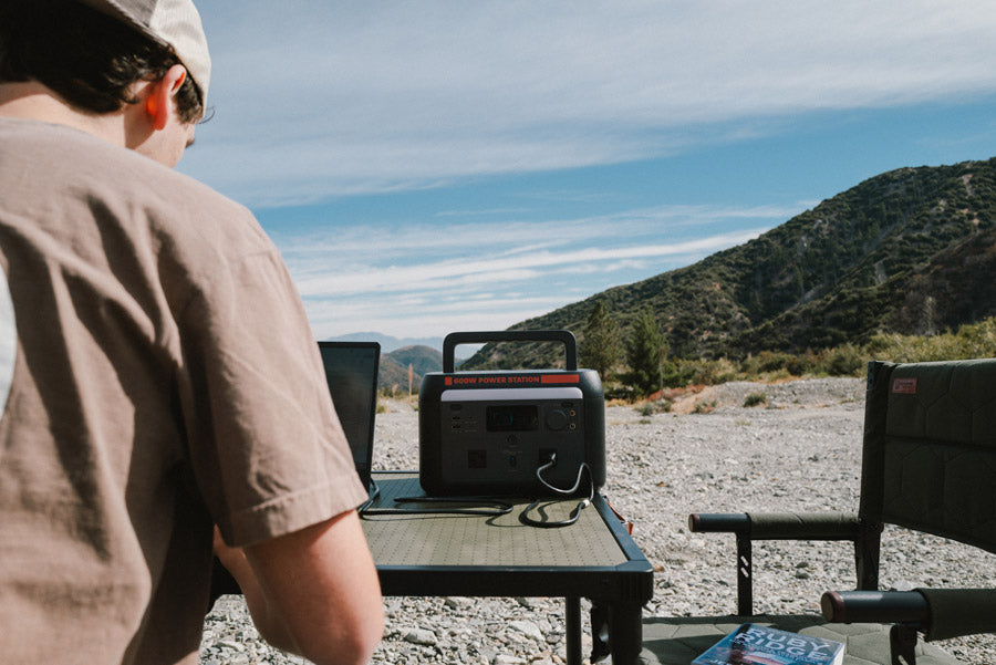 Sasquatch 600W Portable Power Station being used by Man Outside for Workstation