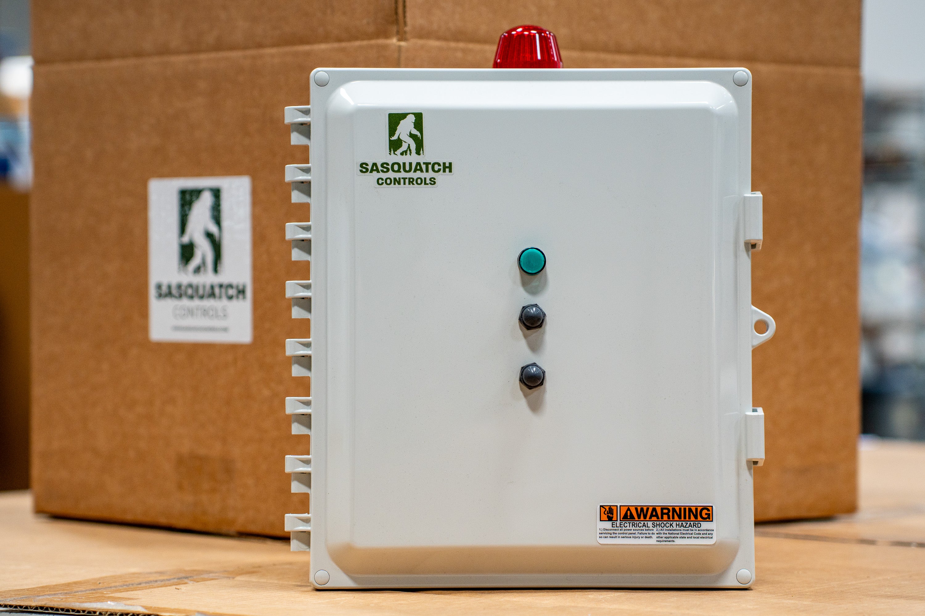 Sasquatch Controls control panel sitting in front of shipping box.