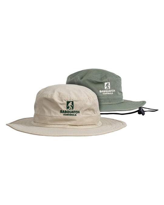 Two bucket hats, one cream and one green, with 'Sasquatch Controls' embroidered logo.