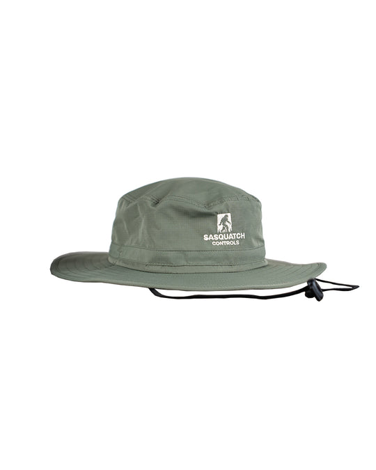 Side angle of green Sasquatch Controls embroidered bucket hat.