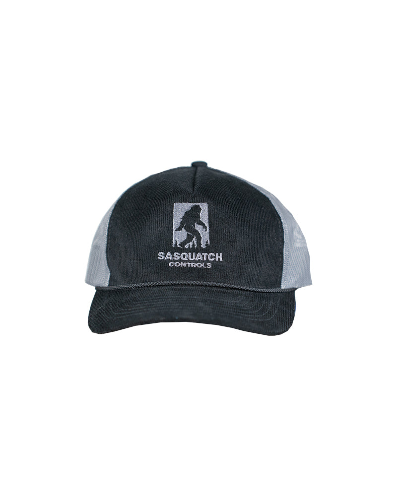 Front of black Sasquatch Controls embroidered corduroy trucker hat.