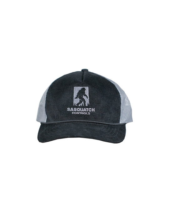 Front of black Sasquatch Controls embroidered corduroy trucker hat.