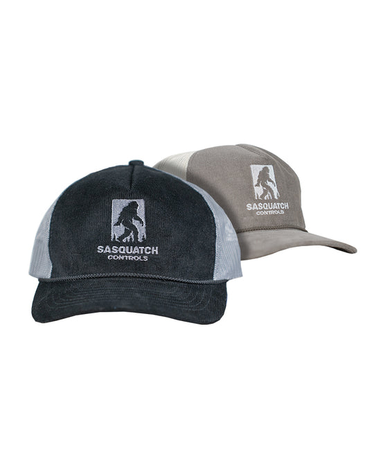 Two corduroy trucker hats, one black and one brown, with 'Sasquatch Controls' embroidered logo.