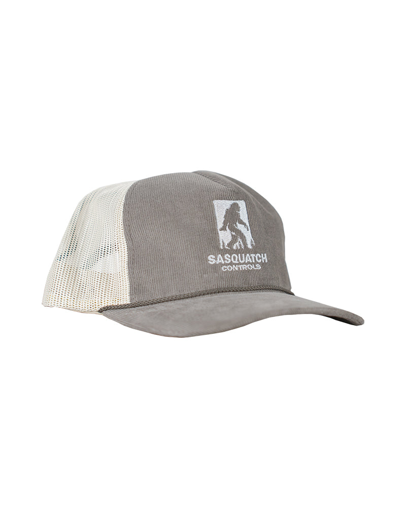 Side angle of brown Sasquatch Controls embroidered corduroy trucker hat.