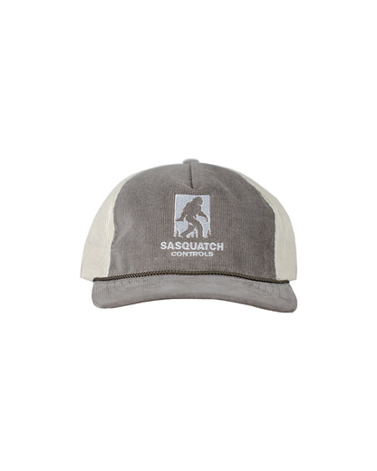 Front of brown Sasquatch Controls embroidered corduroy trucker hat.