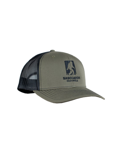 Side angle of green Sasquatch Controls embroidered trucker hat.
