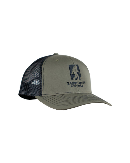 Side angle of green Sasquatch Controls embroidered trucker hat.