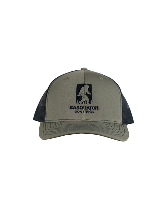 Front of green Sasquatch Controls embroidered trucker hat. 