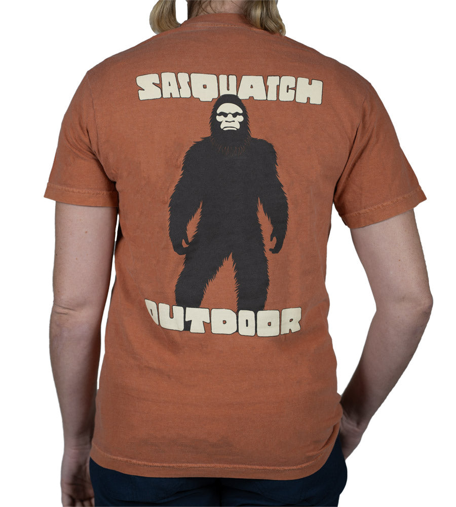 Back of woman wearing Sasquatch Outdoor Silhouette shirt in yam